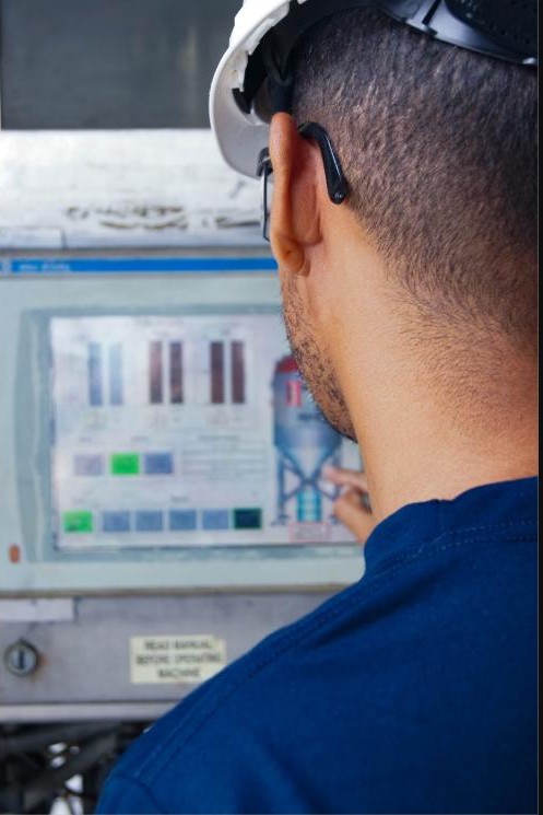 Engineer monitoring a rig floor control panel